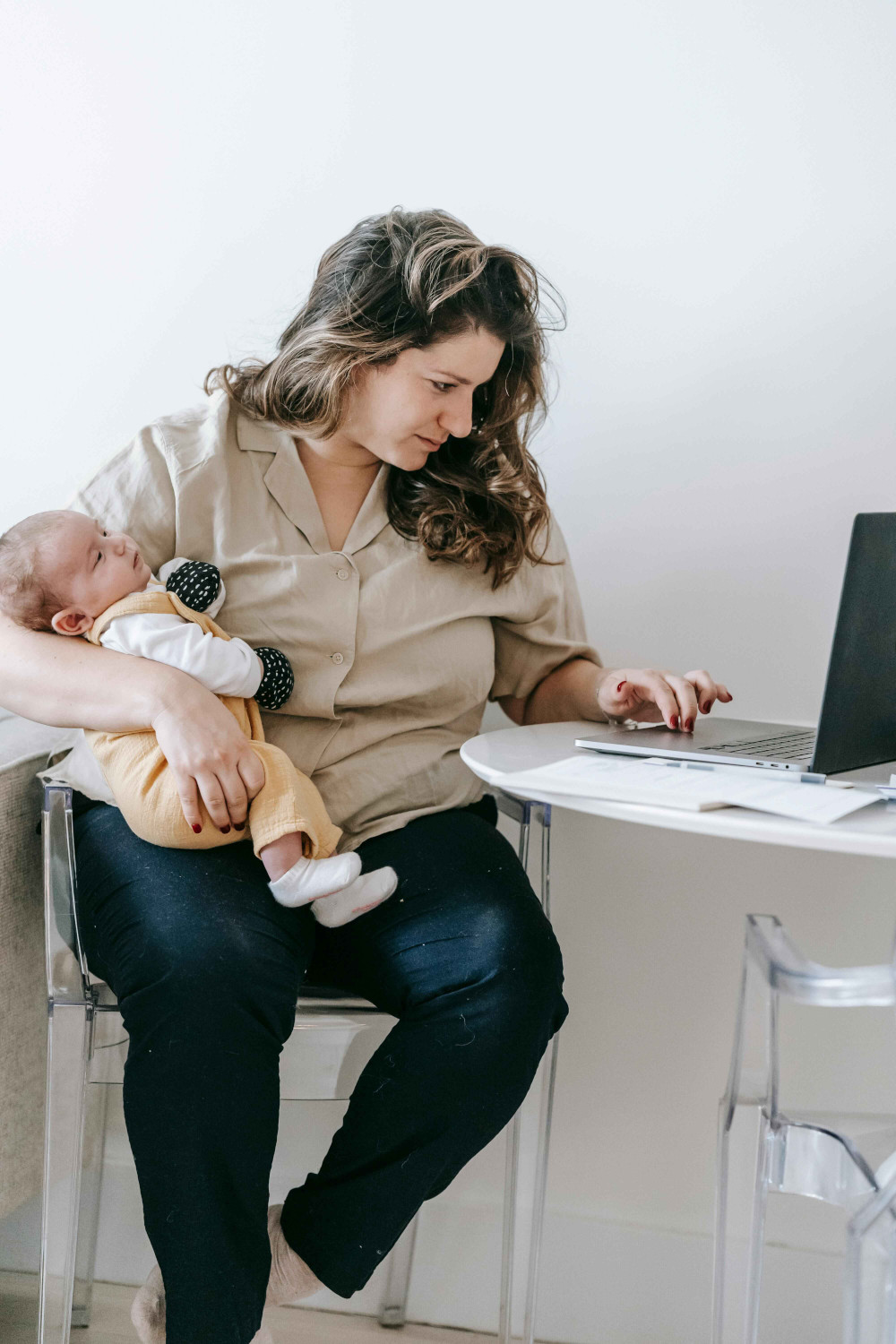 parent with baby on laptop