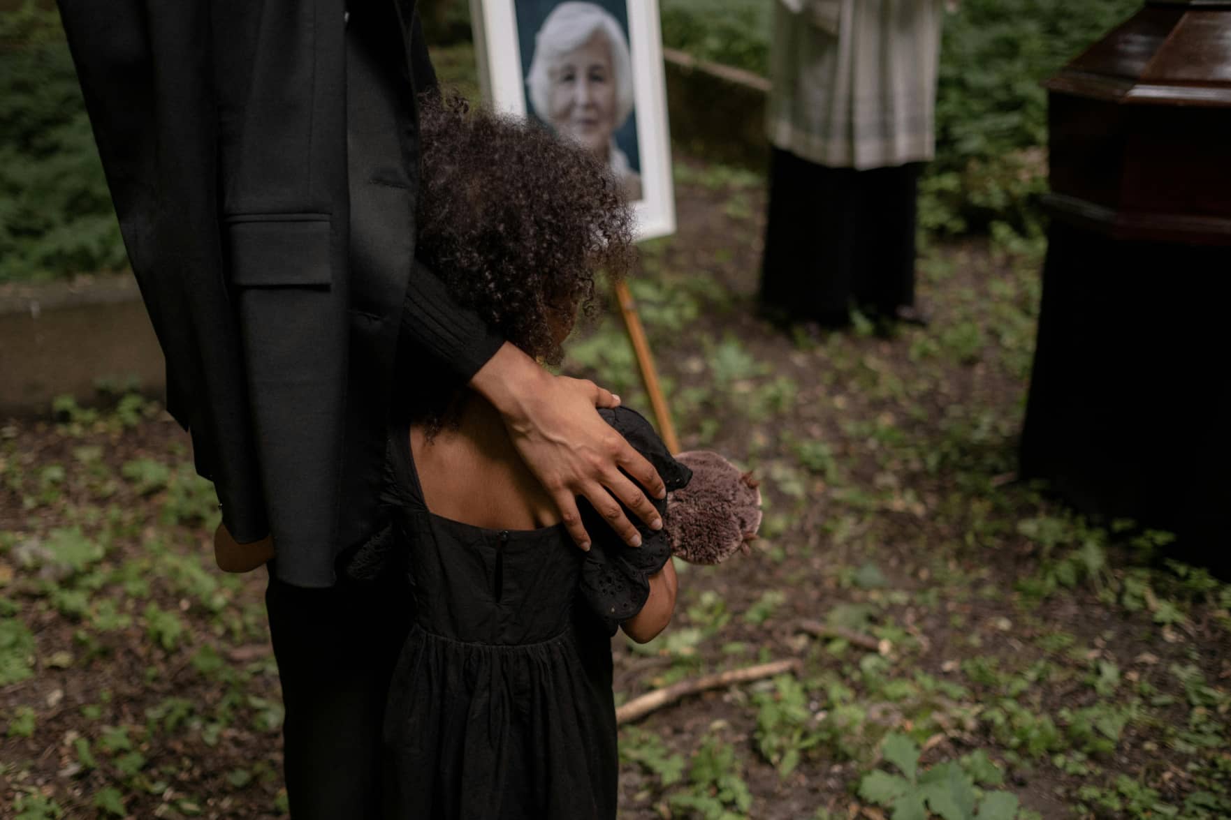 parent comforting child at a funeral